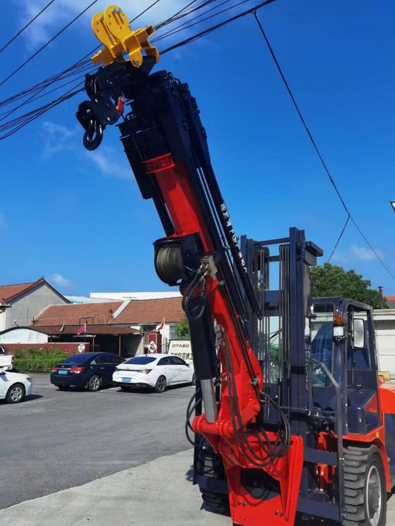 A photo of a red off-road forklift with a 2-stage mast and solid rubber tires in the factory,forklift tow jib