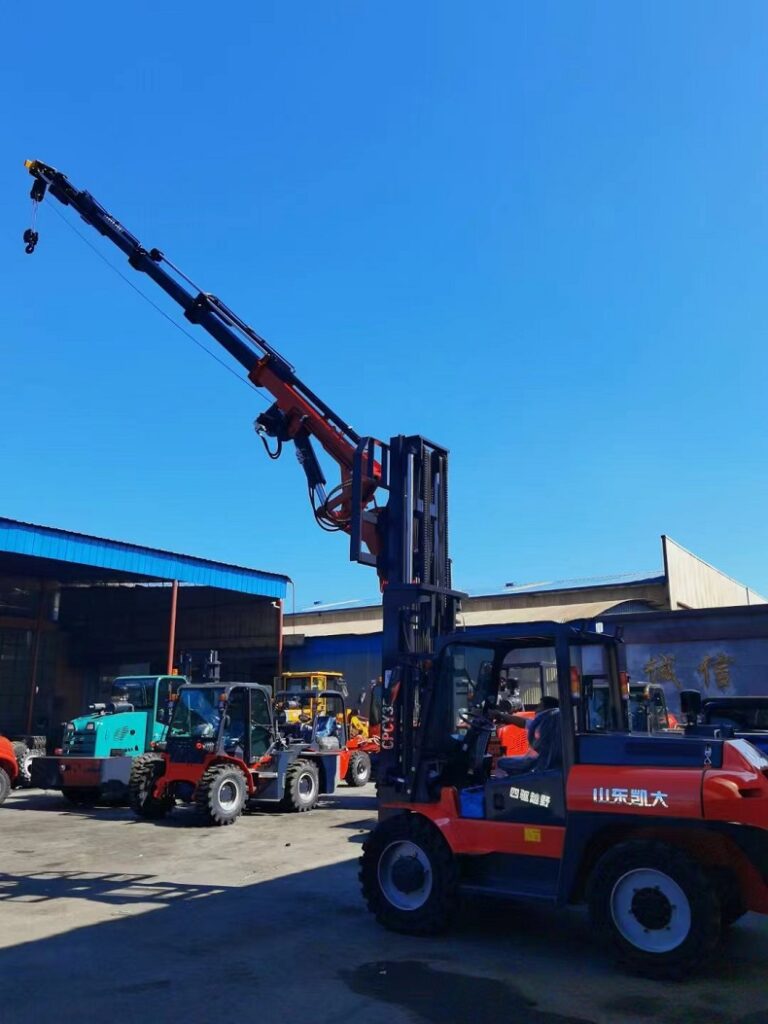 A photo of a red off-road forklift with a 2-stage mast and telescopic boom in the factory
