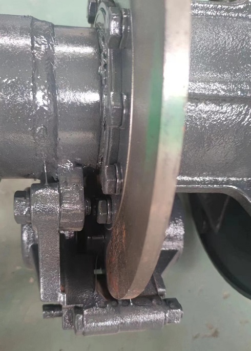 Articulated four-wheel drive forklift brake assembly, brake calipers, brake discs, and brake pads.