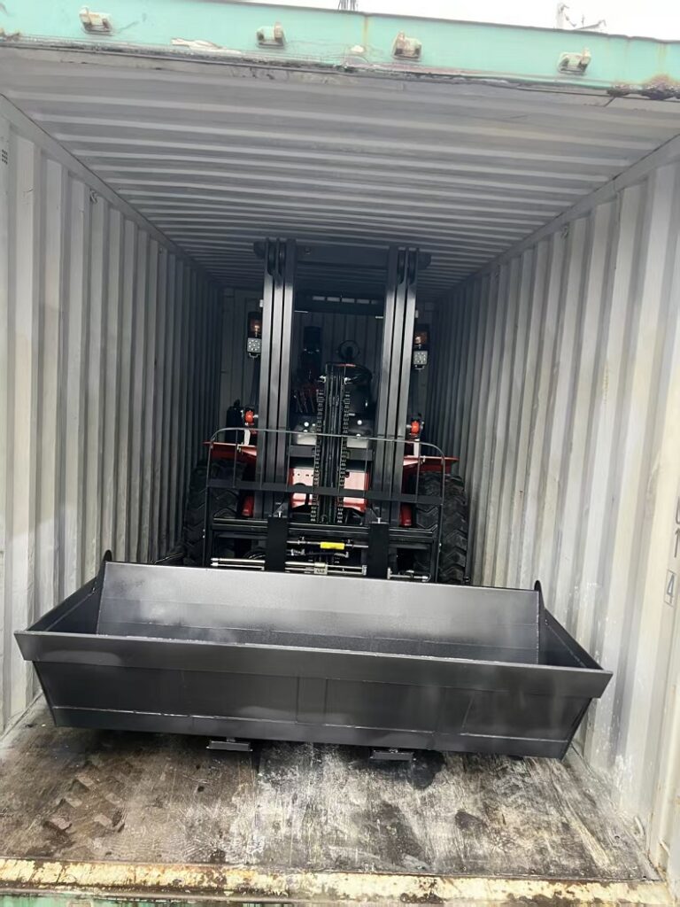 Articulated rough terrain forklift prepared for 20ft container shipping by tire deflation
