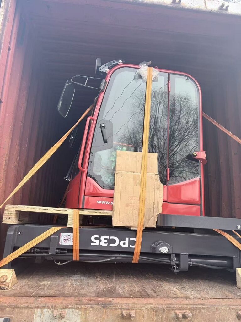 3.5 ton rough terrain forklift being loaded into a 20ft container with cab height adjustment