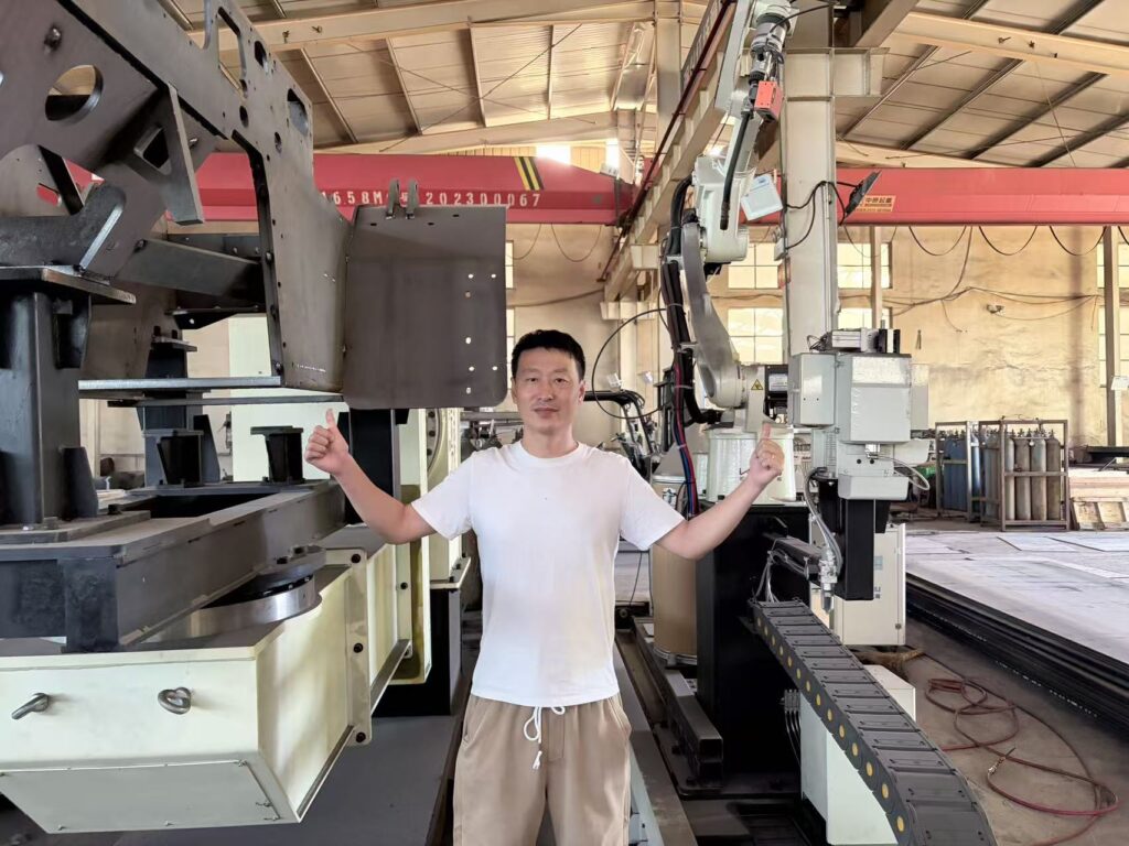 Kaystar Sales Director Derick inspects new automatic welding robot equipment